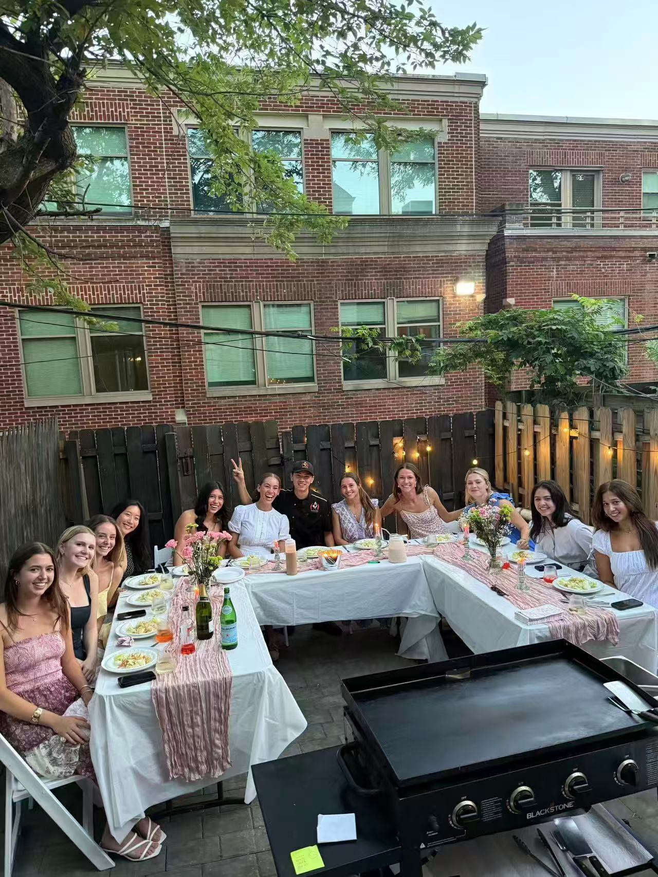 Private hibachi chef setting up grill and cooking at outdoor home party